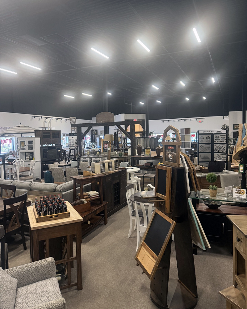 Showroom of Amish furniture for Egg Harbor, sofas, tables, and decor under bright lights.