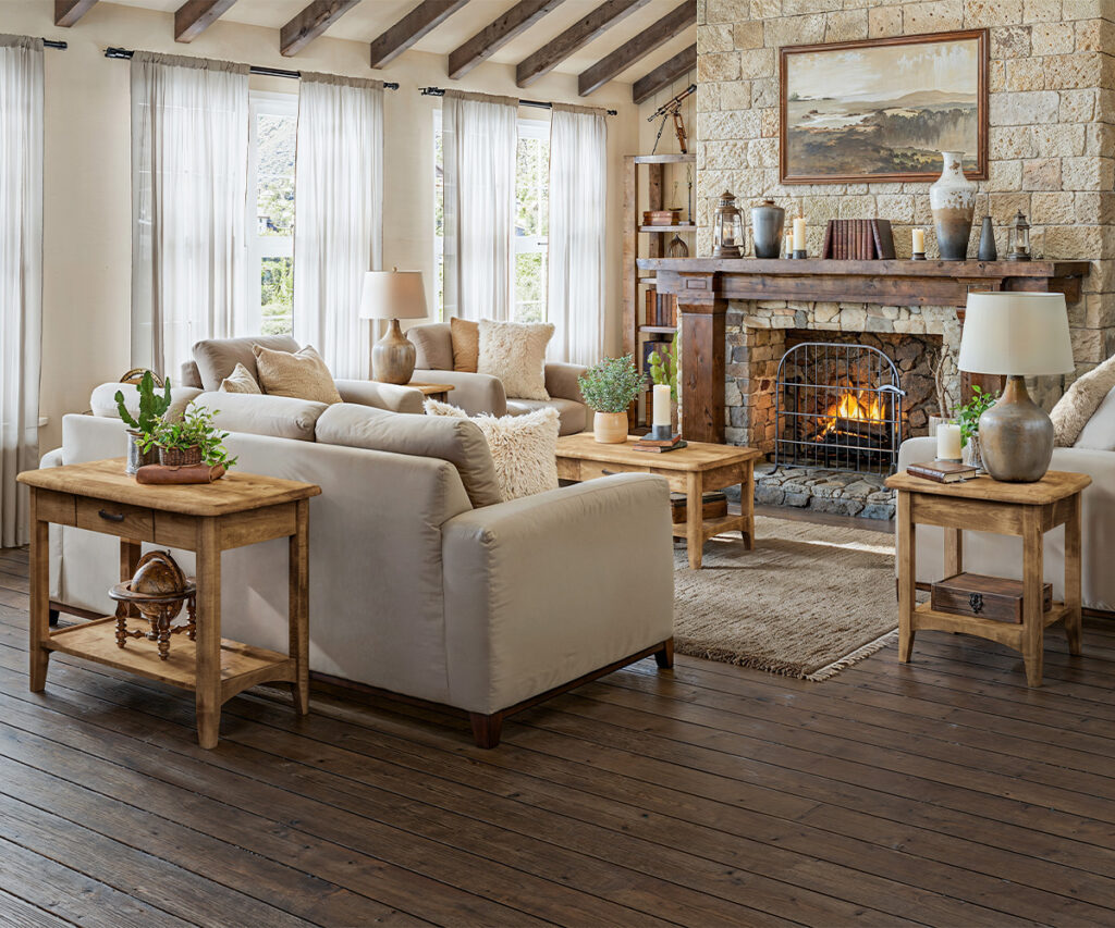 Living room furniture with wood tables, beige seating, and stone fireplace